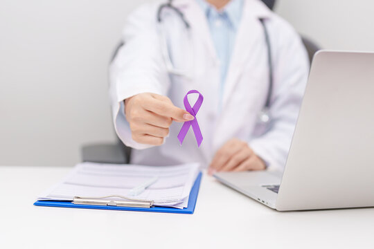 Doctor give purple ribbon for concept of Violence, Pancreatic, Esophageal, Testicular cancer, Alzheimer, Epilepsy, Lupus, Crohn, Sarcoidosis and Fibromyalgia. Awareness month and cancer day