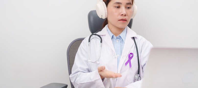 doctor using laptop for telehealth, online consultation and meeting about purple ribbon for concept of Violence, Pancreatic, Esophageal, Testicular cancer, Alzheimer, Epilepsy, Lupus and Fibromyalgia