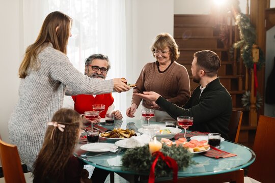 Family enjoying christmas meal serving food