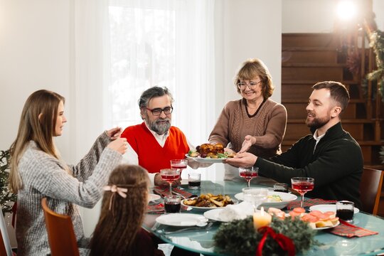 Family enjoying christmas dinner serving festive meal