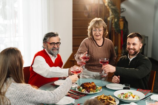 Family celebrating christmas dinner making a toast