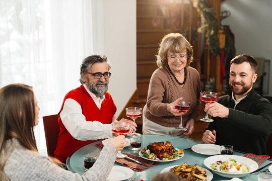 Family celebrating holiday dinner making a toast