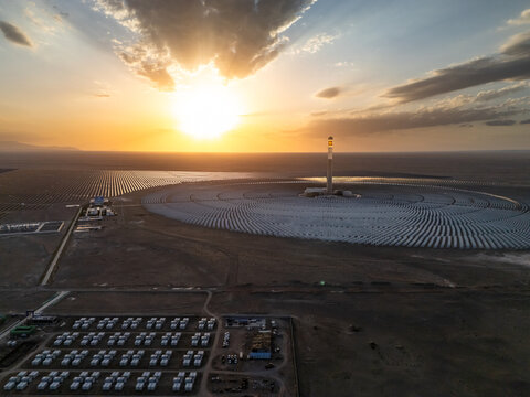 Large scale solar thermal power plant in the desert at sunset