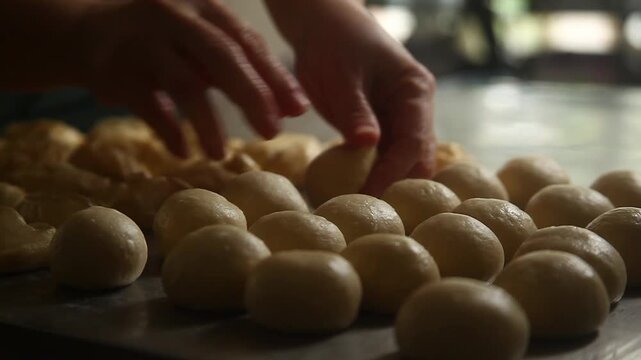 Video of hand preparing dough to be baked as Pan De Sal