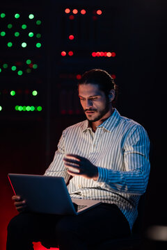 It professional coding on laptop in data center