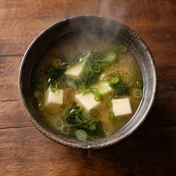 hot miso soup steams in a ceramic bowl