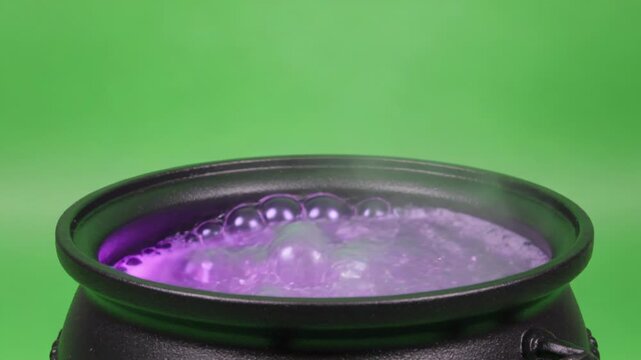 Enchanting dark cauldron, amethyst liquid continuously bubbling with effervescent foam, emitting bright emerald vapor on a clear chroma key