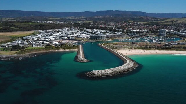 Aerial view of the Shell Cove breakwater and turquoise blue ocean entrance leading to the scenic Shellharbour Marina and beaches, situated on the Illawarra South Coast of New South Wales, Australia.