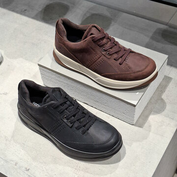 Ecco mens casual leather sneakers in brown and black displayed on modern retail stand on September 23, 2026 in Bangkok, Thailand.