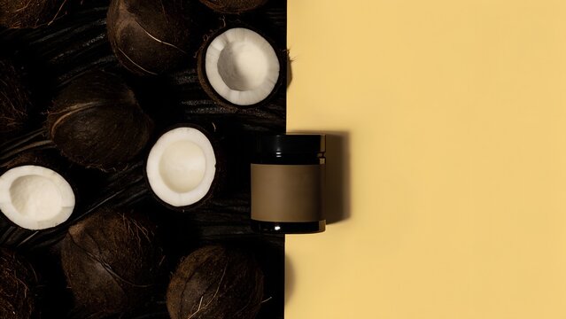 An organic coconut oil jar surrounded by fresh coconut slices