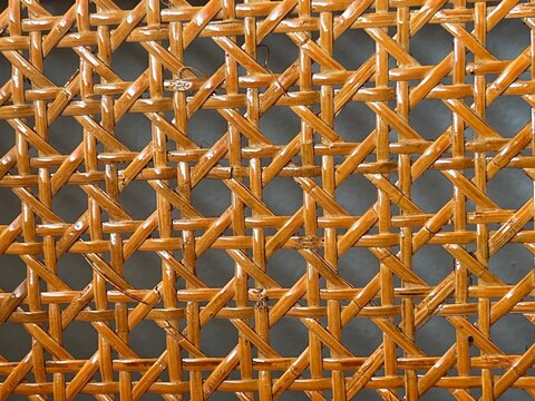 Intricate woven rattan pattern creating a crisscross texture.