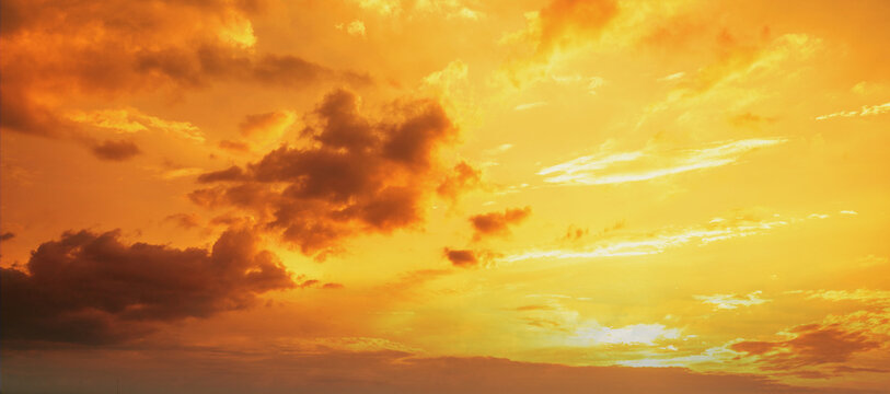 Orange cloudy sky at sunset. Gradient color. Sky texture. Abstract nature background