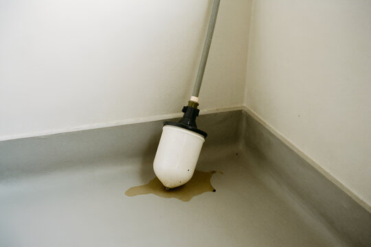 Failed sump pump float switch inside a flooded residential sump pit
