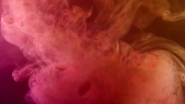 Vibrant pink and orange smoke swirling in abstract patterns on dark background