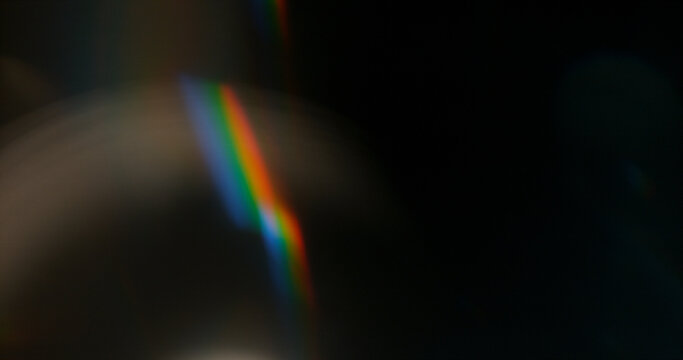 Abstract cinematic lens flare with soft bokeh circles and subtle light reflections. Atmospheric optical effect background ideal for overlays, visual effects, film production and creative design.
