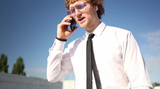 College freshman talks on his smartphone while starting a new chapter of student life combining first year studies with a formal internship and early career experience today