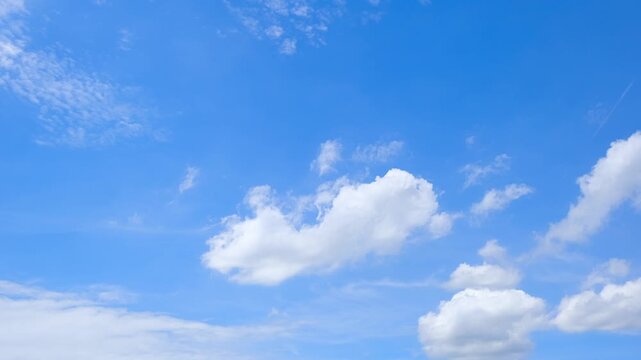 A blue sky cloud timelapse video captures scattered cumulus clouds drifting and reshaping in gentle winds across a vivid blue atmosphere, reflecting bright daylight and pleasant weather. 4k.
