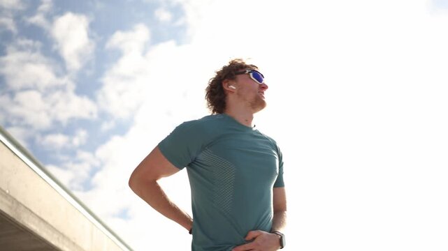 Runner urgently needs a toilet and rushes during outdoor training holding his stomach while trying to reach a restroom as sudden bathroom urgency interrupts his workout