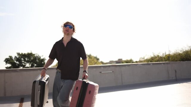 Student moving to a new city runs with two suitcases carrying his belongings while rushing toward a new home and starting an independent chapter of his young life