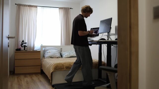 Freelance financial consultant walks on a treadmill while reviewing notes and market data building a flexible work routine that blends business analysis with daily activity