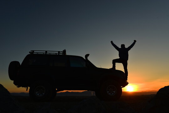 Explorer Celebrating an Off Road Adventure at Golden Hour