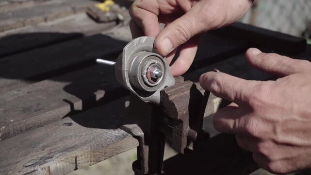 Fabrication of a custom shock-absorption system for an electronic stabilizer and video camera for motorcycle mounting; drilling weight-reduction holes in aluminum parts