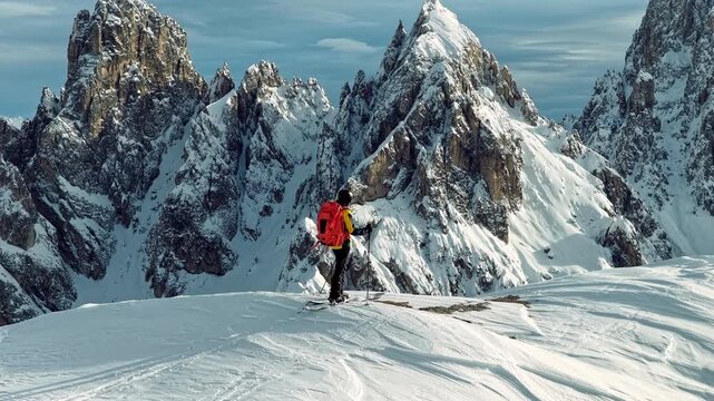 Beautiful Winter Dolomite Mountain Scenery with Man on Cross-Country Skis , Aerial View