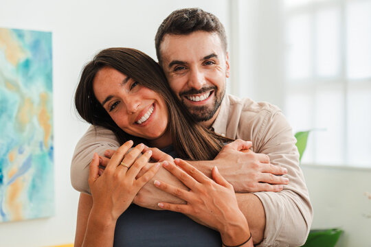 Two people share a close embrace, radiating warmth and happiness. The image captures affectionate connection, mutual trust, and bright smiles, portraying a loving bond and supportive companionship.
