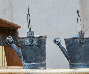 Rustic antique metal watering cans used in Spanish agriculture and viticulture © catocala
