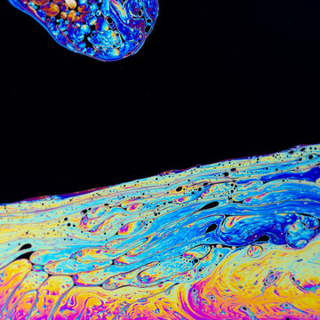 Abstract iridescent soapy surface pattern with copyspace