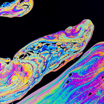Abstract iridescent soapy surface pattern with copyspace