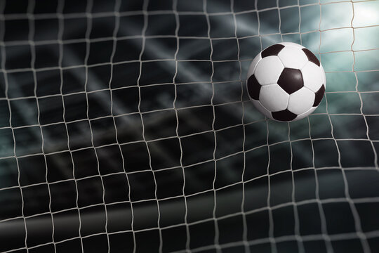 Close-up textured soccer ball in soccer net. isolated on stradium backgrund. score a goal.