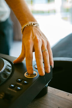 Close-up of DJ hand pressing CUE button on professional CDJ player