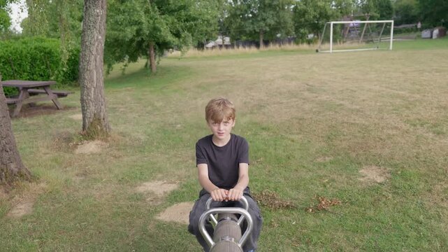A boy with facial tics on a seesaw starts to feel sick