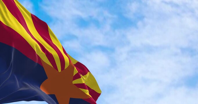 The flag of Arizona waving in the wind on a clear day