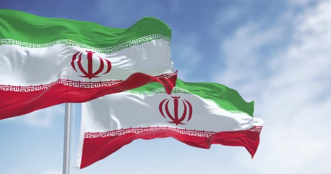 National flags of Iran waving in the wind on a clear day