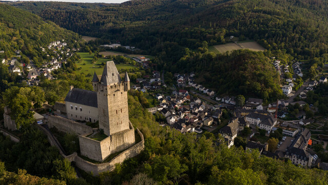 Aerial view of Nassau Castle overlooking the historic town of Nassau nestled in the lush green hills of the Lahn valley in Nassau, Rheinland-Pfalz, Germany.