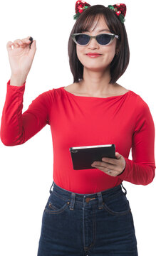 Happy young asian woman holding pen write air content christmas sale black friday promotion wearing dark sunglasses festive headband red shirt isolated transparency background