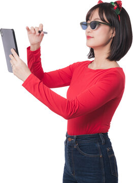 Happy young asian woman wearing sunglasses holding tablet and pen for christmas sale offer during black friday shopping event isolated on transparency background