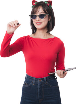 Happy young asian woman wearing sunglasses holding marker during christmas holiday season black friday shopping sale event over isolated transparency background
