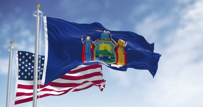 New York State flag waving with the American flag on a clear day