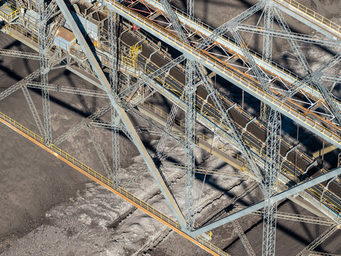 Aerial view of the Tagebau Welzow-Sud brown coal open-pit mine featuring a massive industrial conveyor system and steel truss structures in Spremberg, Brandenburg, Germany.