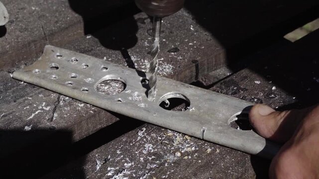 Fabrication of a custom shock-absorption system for an electronic stabilizer and video camera for motorcycle mounting; drilling weight-reduction holes in aluminum parts