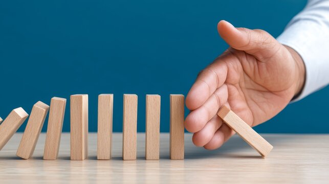 Hedging, Business Risk Management, Preventing Financial Losses. Halting Domino Effect - Risk Mitigation Strategy Concept with Human Hand Preventing Dominoes from Falling, Copy Space