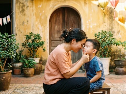 Mother and son sharing a tender moment in a sunny courtyard