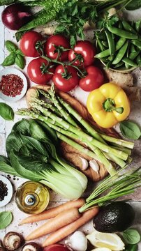 Table Top with Fresh Vegetables Background. Fresh Raw Vegetables Asparagus Tomatoes and Olive Oil Organized for Cooking 4K
