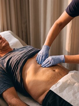 Gentle physical examination of a tender abdomen area