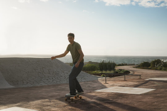 Young man having fun at skateboard park outdoor at sunset - Extreme sport concept - Main focus on face - UGC content