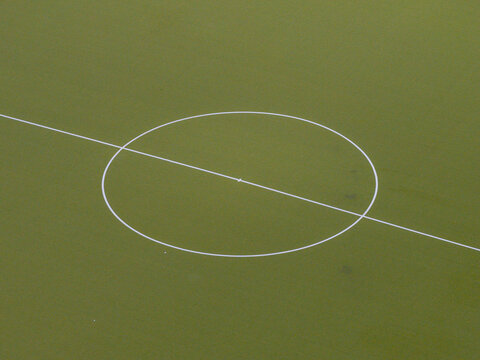 Aerial view of a soccer field center circle with white markings on green artificial turf in Berlin, Berlin, Germany.