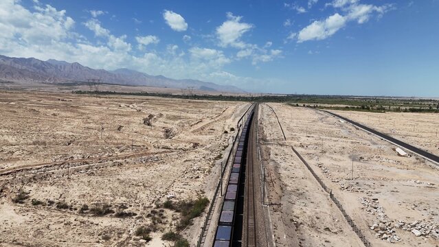 long freight train stretching across the desert landscape